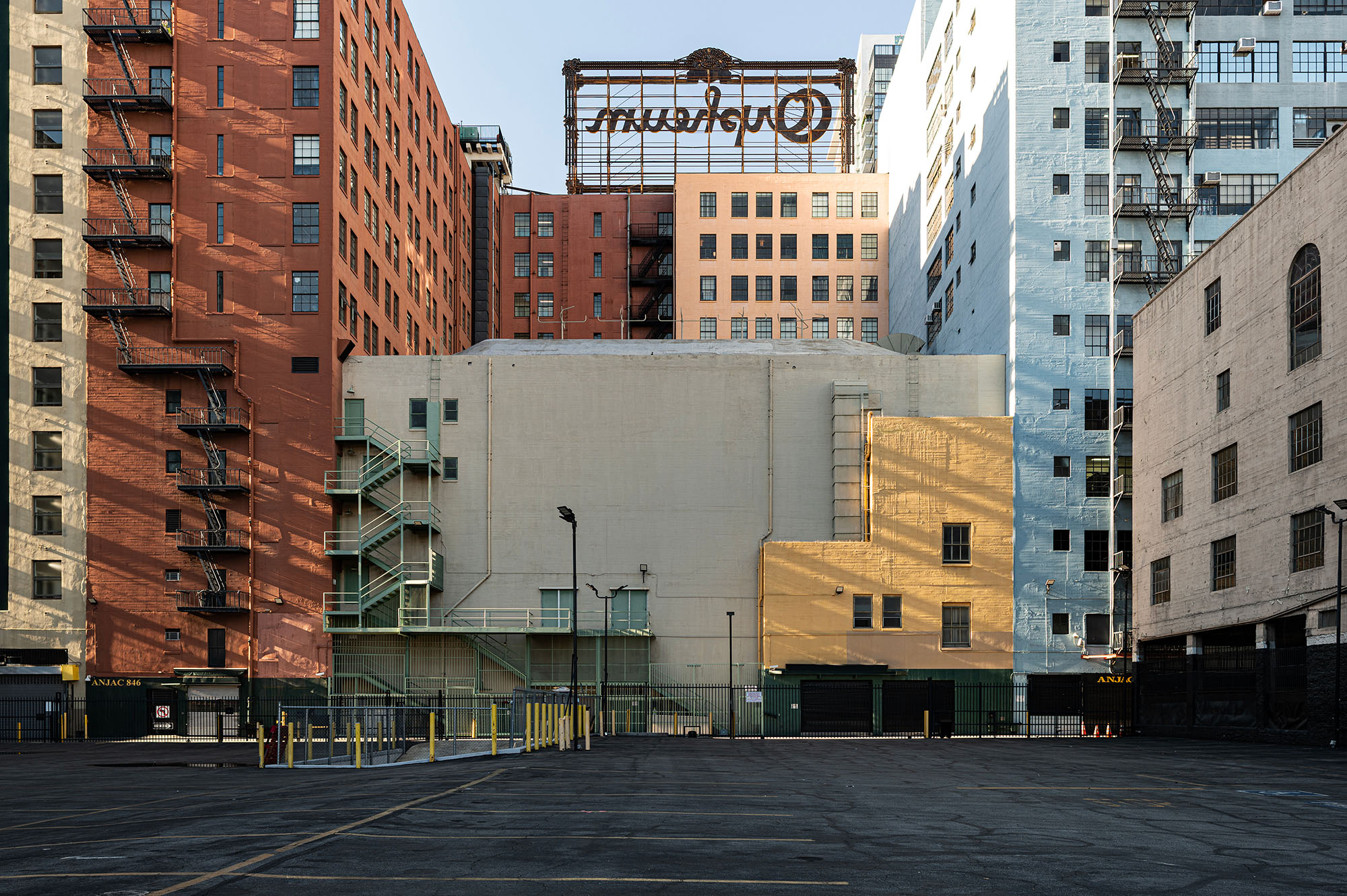 Erik de Geus art photo Bram breit - He knits Broadway Downtown LA pastel colored art deco backside high rise brownstone buildings